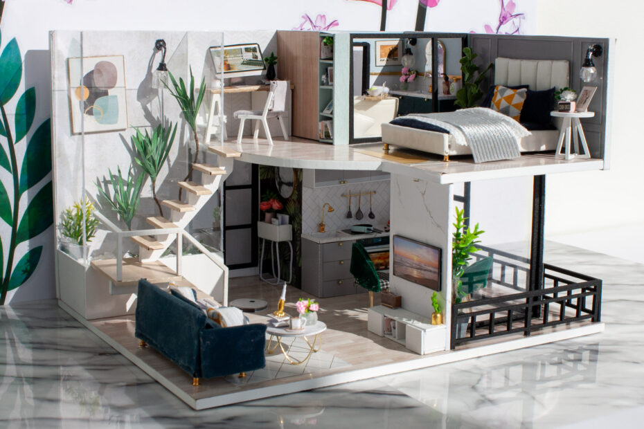 Model dreamhouse interior placed on a marble floor and flower sticker backdrop